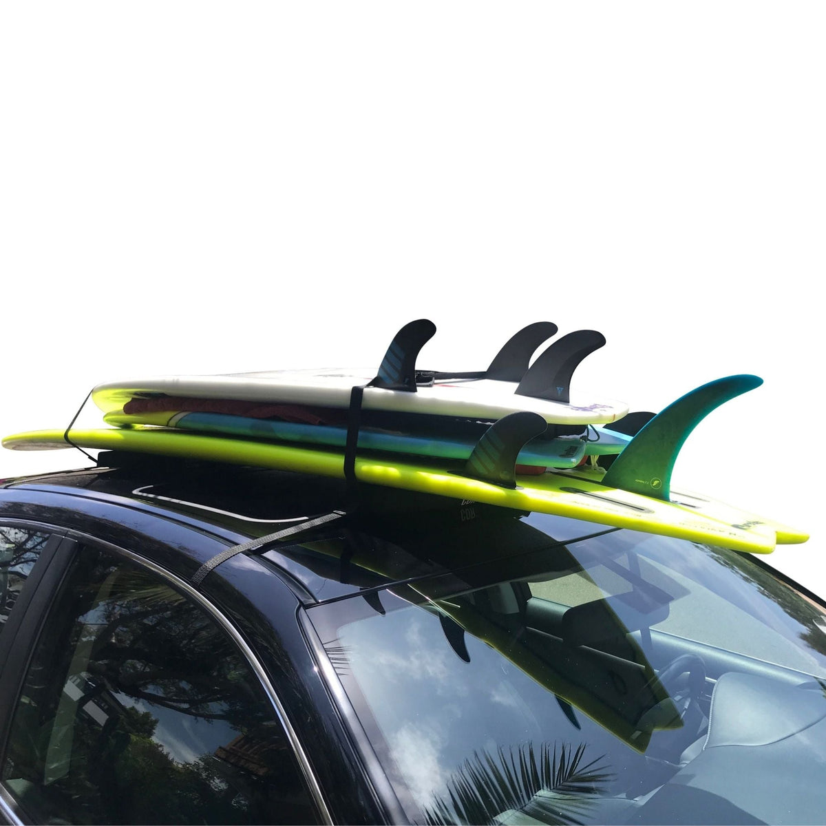 COR Surf universal soft roof rack secured around a vehicle roof with a surfboard on top.